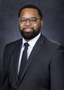 Portrait photo of Dr. Quincy Bevely in a suit and tie. 