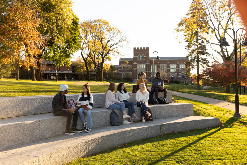 Students in outdoor classroom, with Ruane in the background